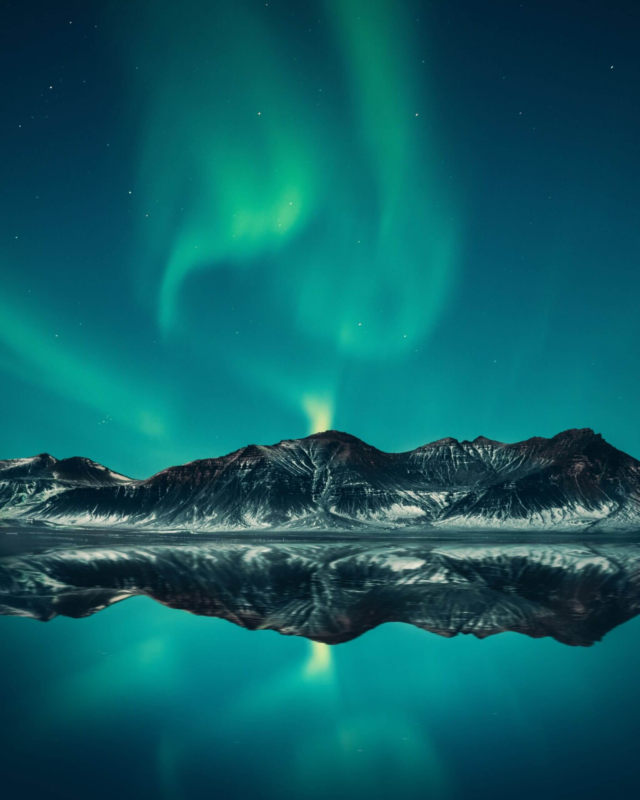 Mountain view with aurora borealis on night sky